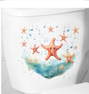 Detailed view of ocean starfish and blue notes stickers on a white ceramic toilet tank