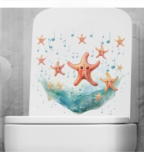 Close-up of cartoon starfish and musical notes sticker on a white toilet cover