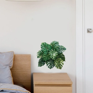 Realistic tropical monstera leaf wall decals in a modern bedroom interior setting