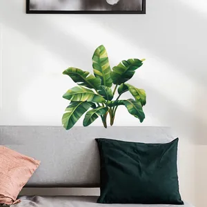 Detailed view of tropical monstera leaf wall stickers on a modern white living room wall