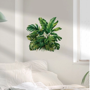 Close-up of tropical monstera and palm leaf wall stickers on a modern bedroom wall