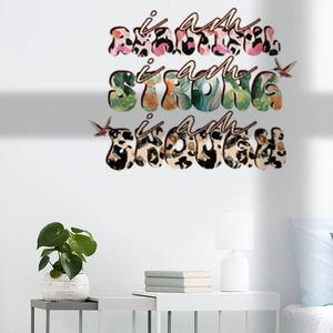 Macro detail of motivational wall stickers with leopard print text and colorful hummingbirds