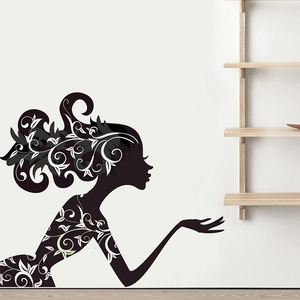 Detail of female silhouette wall sticker with white vine floral patterns on a white wall