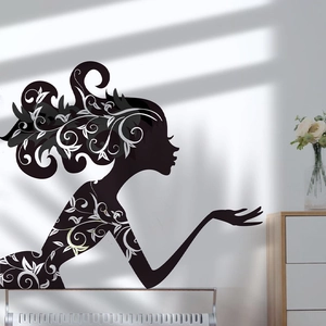 Detail of artistic woman silhouette wall sticker with floral patterns on a white wall