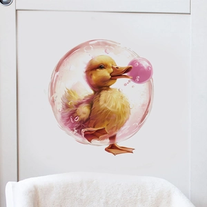 Detail of cartoon yellow duck wall decal blowing a pink bubble on white furniture surface