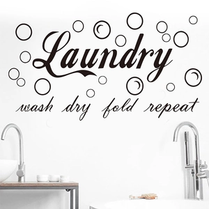Detail showing 'Laundry' bubble wall sticker with 'wash dry fold repeat' text in black
