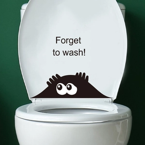 Close-up of funny cartoon monster toilet sticker with Forget to wash warning text