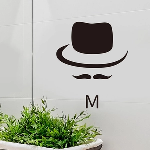 Detail of vintage gentleman silhouette wall sticker with hat and mustache on grey tiles