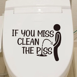 Close-up of funny stickman sticker with humor text on a white ceramic toilet lid