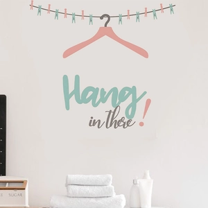 Detail of Hang in there wall sticker with colorful laundry line and drying hangers
