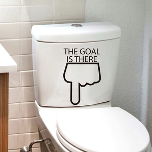 Close-up of black 'THE GOAL IS THERE' waterproof PVC decal on a white toilet tank