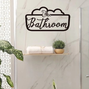 Detail of The Bathroom black wall art signage installed in a modern marble bathroom setting
