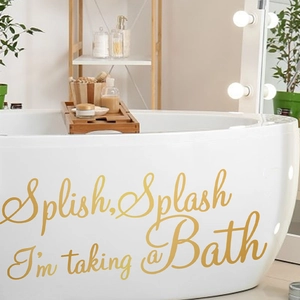 Detail of Splish Splash gold lettering wall decal applied on white ceramic bathtub