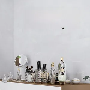 Detail of BE BEAUTIFUL INSIDE & OUT wall sticker on marble wall with cosmetic accessories
