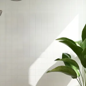 Detail of 'BE beautiful INSIDE & OUT' black vinyl wall sticker on white bathroom tiles