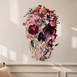 Floral skull wall decal with birds and leaves in a romantic gothic style on white wall