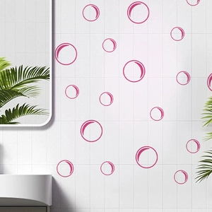 Detailed view of pink bubble wall stickers applied on white bathroom tiles decoration