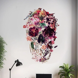 Artistic floral skull wall decal with birds and leaves on a clean white living room wall