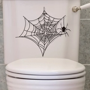Détail de l'autocollant toile d'araignée noire sur le réservoir des toilettes blanc