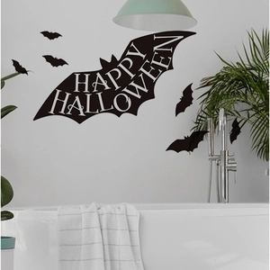 Close-up of black Halloween bat wall stickers with Happy Halloween text in a modern bathroom