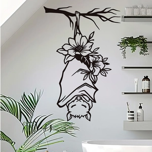 Detail of cartoon hanging bat wall sticker with sunflower on a clean white bathroom wall