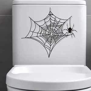 Détail d'autocollant d'araignée noire et toile d'Halloween sur une surface en céramique
