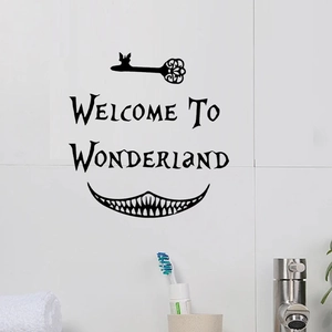 Detail showing Wonderland wall sticker with key and cat smile on white bathroom tiles