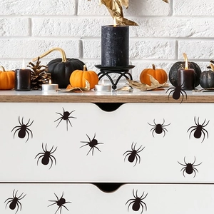 Detailed view of black spider wall decals applied on furniture for Halloween decor