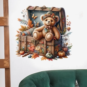 Detail showing a cute teddy bear inside a wooden chest with autumn maple leaves wall sticker