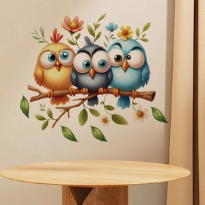 Detailed view of colorful big-eyed cartoon birds on branches as wall decor in a nursery room