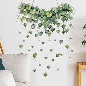 Detailed view of watercolor heart-shaped green leaf wall decals in a modern living room