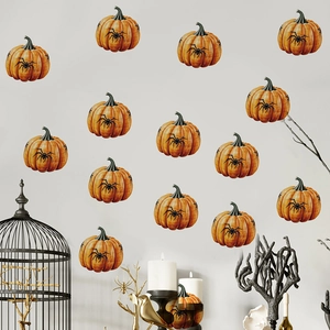 Detail of Halloween pumpkin wall stickers with black spider icons on a grey wall