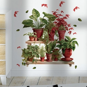 Detail of vintage PVC wall decals showing potted plants and red leaves on white wall