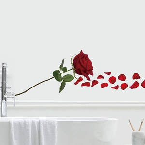 Detail of red rose bathtub wall stickers with floating petals on white tiled background