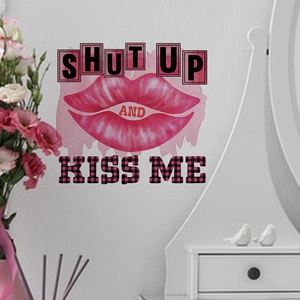Detail of Shut Up And Kiss Me wall sticker with pink lip prints on white cabinet