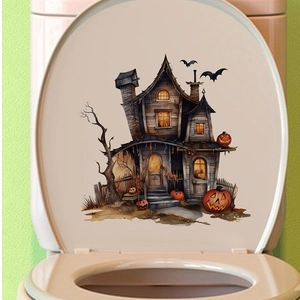 Detail showing a Halloween pumpkin castle decal applied to a white ceramic toilet lid