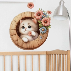 Detail of cute kitten wall sticker in wooden circle with flowers on white wall