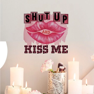 Detail of pink lip wall sticker with 'SHUT UP AND KISS ME' artistic lettering design