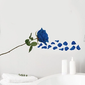 Detailed view of waterproof blue rose wall sticker with realistic petals on a white wall