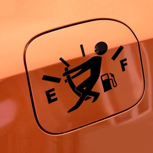 Detail shot of a funny stick figure vinyl decal moving fuel gauge needle on a car gas tank