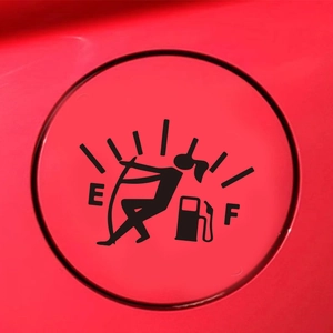 Close-up of a creative cartoon gas gauge sticker on a red car fuel tank cover