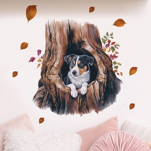 Detail of a cartoon dog in a tree hole wall sticker with autumn leaves on a white wall