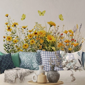 Detailed wall sticker showing realistic yellow sunflowers, daisies, and butterflies on a wall