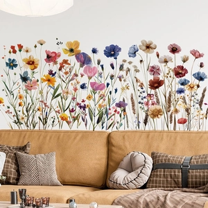 Living room wall decor showing colorful hand-painted wildflowers above a sofa