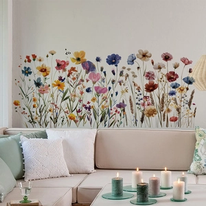 Artistic painted wildflowers wall stickers displayed above a cozy beige living room sofa