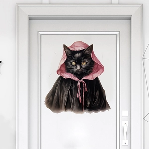 Detail of Halloween black cat wall sticker with pink cloak on a white interior door
