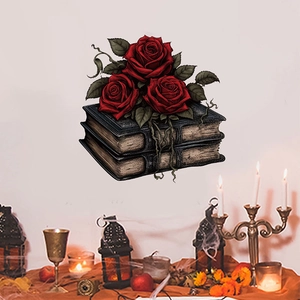 Gothic wall sticker detail with red roses on vintage books and mystical candle setup