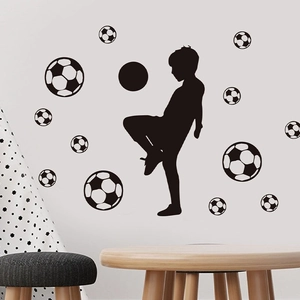 Black silhouette wall sticker of boy playing soccer with multiple football decals