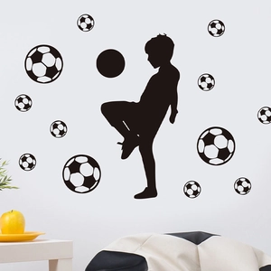 Detail of soccer boy silhouette and various size football wall stickers on white wall