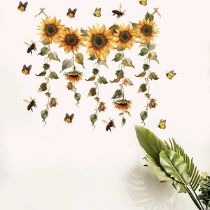 Detail of sunflower wall stickers with bees and butterflies on a white wall background